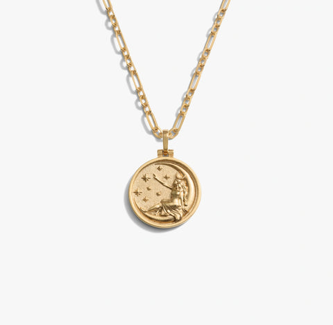Gold necklace with a zodiac pendant on a white background
